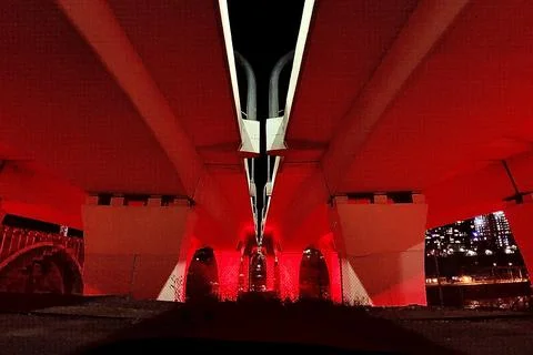 Red dramatic lighting under a bridge at night Stock Photos