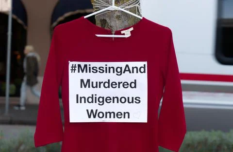 A red dress with text "Missing And Murdered Indigenous Women" Stock Photos