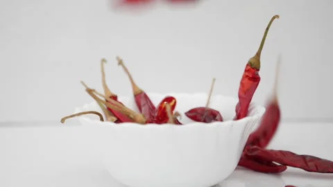 red dried chilli pepers falling into Stock Video Pond5