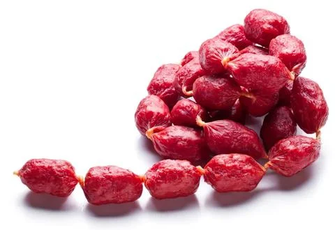 Red dried dates arranged on white surface Stock Photos