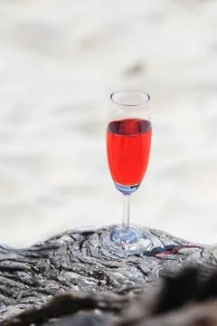 Red drink on beach with ocean Stock Photos