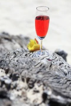 Red drink on beach with ocean Stock Photos