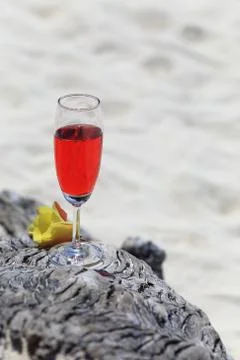 Red drink on beach with ocean Stock Photos