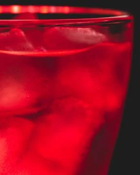 Red drink with ice cubes Stock Photos