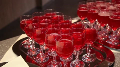 Red drinks in glass cups on the table 動画素材 64289449