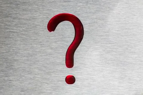 Red drops in the form of a question mark. The surface is metallic. Stock Photos