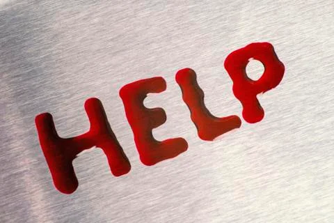 Red drops in the form of a word help. The surface is metallic. Foto stock