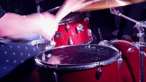 Red drum kit with blurred sticks under purple stage light on dark concert stage Stock Footage 344967781