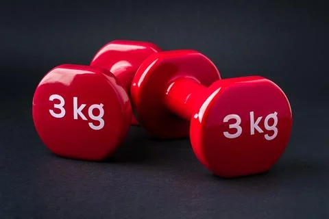 Red dumbbells pair representing strength balance and fitness training concept 스톡 사진