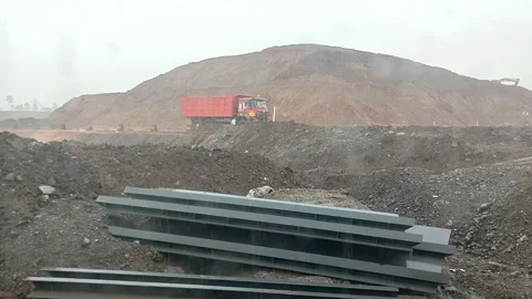 Red Dump Truck Passing Through Construction Site During Heavy Rain Stock Footage 340124498