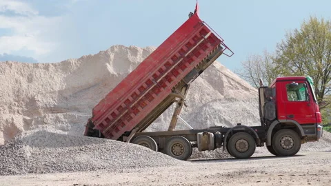 The red dump truck pours rubble from the body. General plan. Stock Footage 130190501