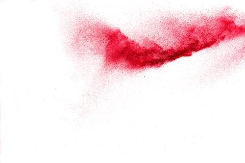 Red dust particles explosion on white background.Red sand splatter. Stock Photos