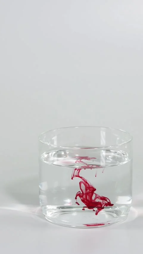 Red Dye Diffusing in Water Glass Video stock 304726819