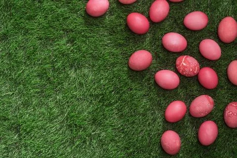 Red dyed Easter eggs rest on lush green grass with generous copy space, cre.. Fotos Stock
