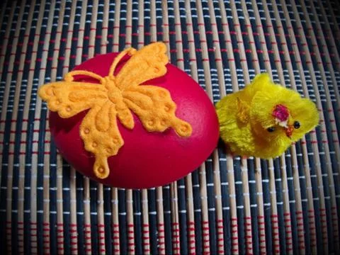 Red Easter egg and a cute little yellow chick. Stock Photos