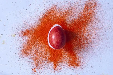 Red easter egg with color spread Stock Photos