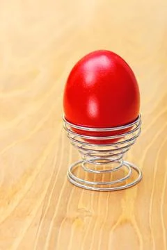 Red easter egg in metallic spiral cup Stock Photos
