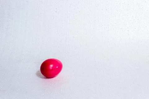 Red Easter egg in one copy, on a white background. Stock Photos