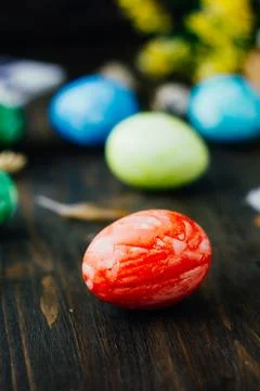 Red easter egg over brown wooden table. Stock Photos