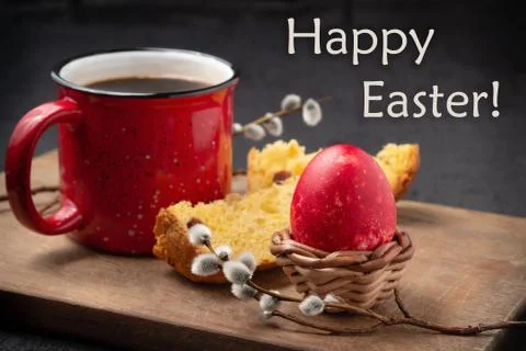 Red Easter egg, slice of Easter cake, cup of coffee on a cutting board on a d Stock Photos
