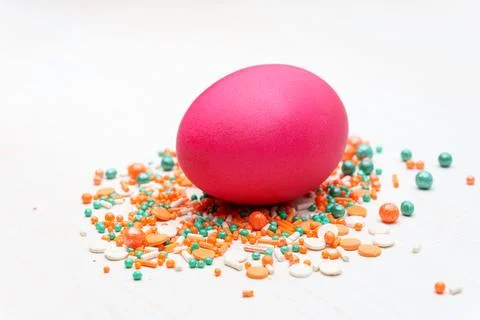 Red Easter egg on a white table with decorations Stock Photos