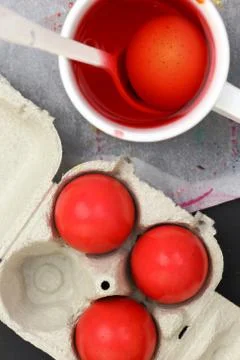 Red Easter eggs and liquid dye Stock Photos