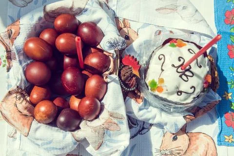 Red easter eggs in basket, Ester cake with candle Stock Photos