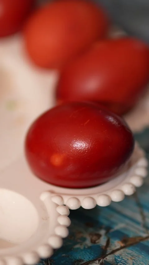 Red Easter eggs on a decorative plate with blurred background Stock Footage 332610781