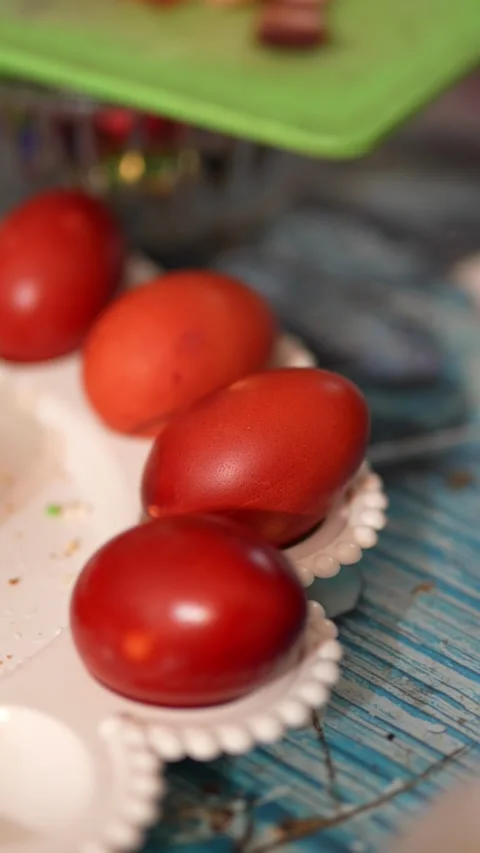 Red Easter eggs on a decorative plate with blurred background Stock Footage 332610846