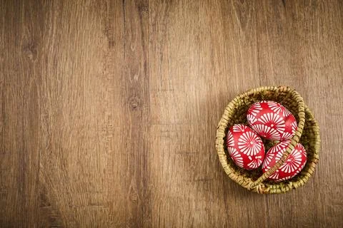 Red easter eggs with floral pattern in basket Stock Photos