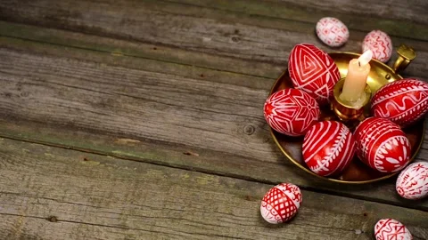 Red easter eggs with folk Ukrainian pattern and candlestick on vintage boards Stock Footage 127887428