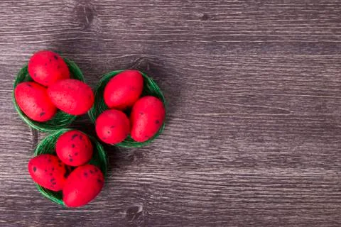 Red Easter eggs on green nest Stock Photos