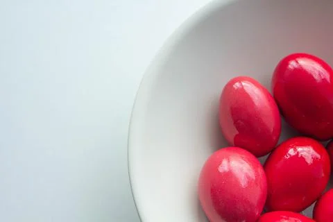 Red easter eggs in white ceramic bowl Stock Photos