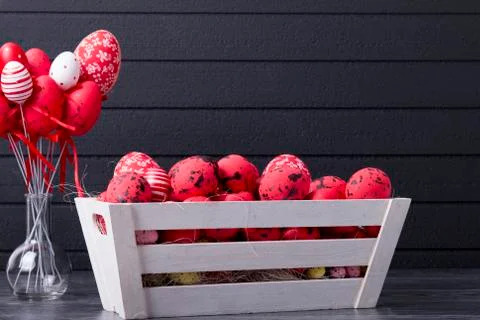 Red Easter eggs in a wooden container Stock Photos