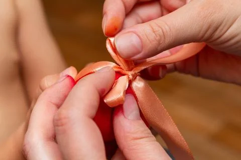 Red egg with bow in hands for the Easter Stock Photos