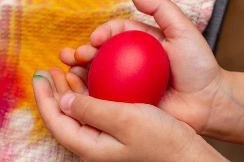 Red egg in hands for the Easter Stock Photos