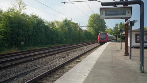 Red Electric Commuter Train Arriving at Outdoor Railway Station in Copenhagen Stock Footage 345118314