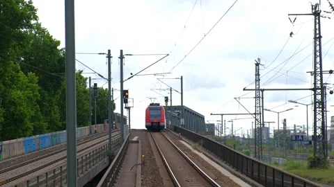 Red electric passenger train approaching on elevated bridge track with over.. Vídeo Stock 337405016