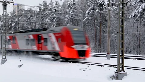 Red electric train moves through winter forest Stock Footage 102879166