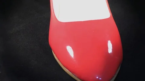 Red elegant shoes on the circle and rotating on wheel and black surface. Stock Footage 111273977