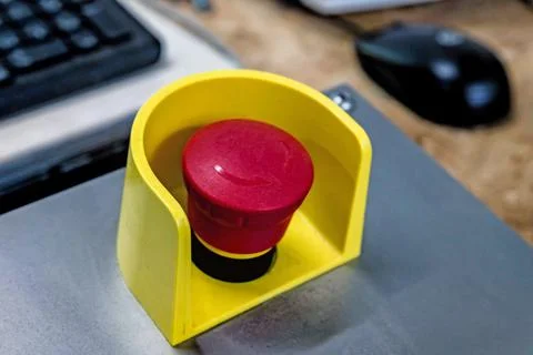 Red emergency button on black panel. Stop Stock Photos