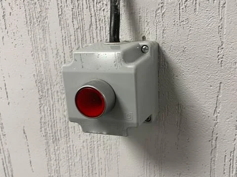 Red emergency button on a white wall Stock Photos