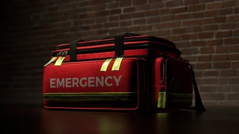The red emergency first aid bag against a brick wall. Ambulance lights blinking. Stock Footage 112597591