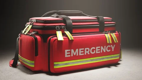 The red emergency first aid bag in the studio spotlight. Paramedic kit. 4KHD Stock Footage