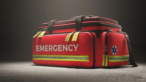 The red emergency first aid bag in the studio spotlight. Paramedic kit. 4KHD Stock Footage 112601747