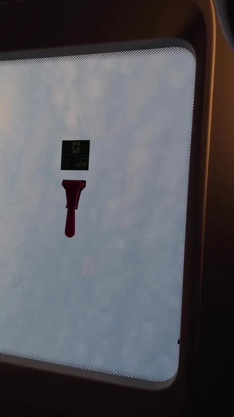 Red emergency hammer mounted under instruction decal inside skylight interior 動画素材 345660221