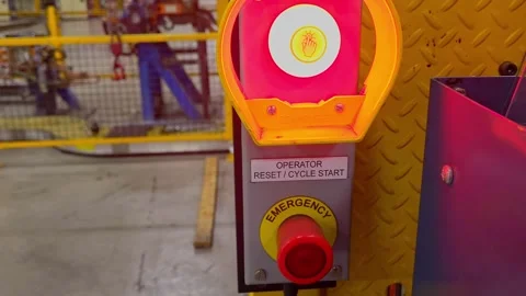 Red emergency stop button activating machine safety on a manufacturing plant Stock Footage 334647555