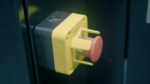 The red emergency stop button for the equipment in the yellow body  Stock Footage 323966391