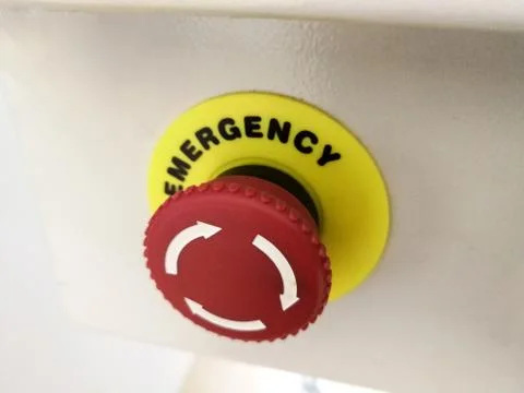 Red emergency stop button on industrial machinery Stock Photos