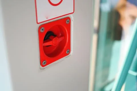 Red emergency switch on a train station wall Stock Photos